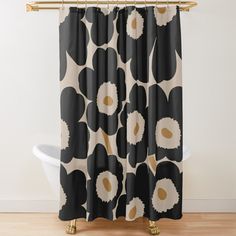 a black and white shower curtain with an abstract flower design on it's side