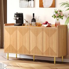 a wooden sideboard with drinks on it in a living room next to a window