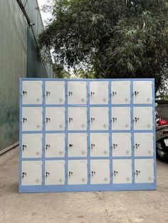 a bunch of lockers sitting in front of a building on the side of a road