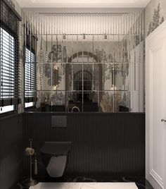 the bathroom is decorated in black and white with mirrors on the wall above the toilet