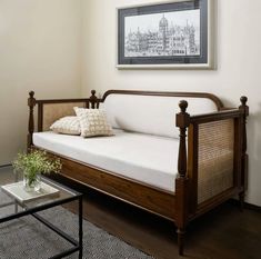 a living room with a couch, coffee table and pictures on the wall above it