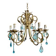 an antique chandelier with blue crystal drops hanging from it's center arm