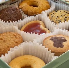 a box filled with lots of different flavored donuts