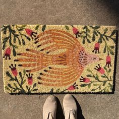 a person standing in front of a door mat