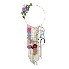 a wind chime with flowers and beads hanging from it's center circle on a white background