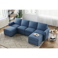 a blue sectional sofa sitting on top of a rug