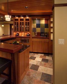 a kitchen with wooden cabinets and black counter tops