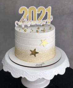 a white cake with gold stars on top