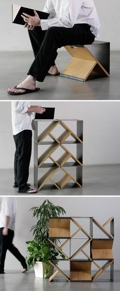 a man sitting on top of a book shelf next to a plant