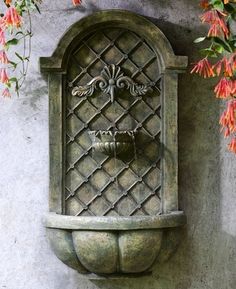 a water fountain mounted to the side of a wall