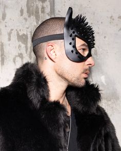 Masquerade Mask - Spiked, Black Cat Step into the wild with our Black Cat Masquerade Mask. This spiked masterpiece is crafted from lightweight materials for all-night comfort, giving you a fierce, head-turning look without compromise. Perfect for Halloween costumes, cosplay conventions, music festivals, or any event you want to show off your inner feline. The sleek black design and bold spikes are made to make a statement -- trust us, if you pair this with one of our coats or hoods, you're bound