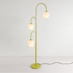 a floor lamp with four lights on each side and a cord running through the middle