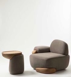 the modern chair and ottoman are both made from wood, fabric or wool with an upholstered design