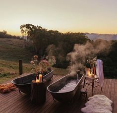 an outdoor hot tub on a deck with candles