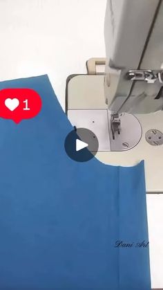 the sewing machine is working on the blue material that has been sewn into it