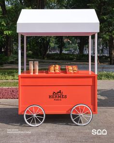 an orange and white cart with some food on it