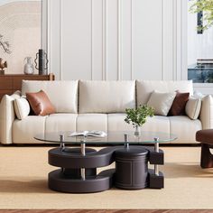 a modern living room with white couches and coffee tables