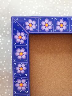 a blue frame with flowers painted on it