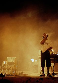 a man standing on top of a stage next to a keyboard