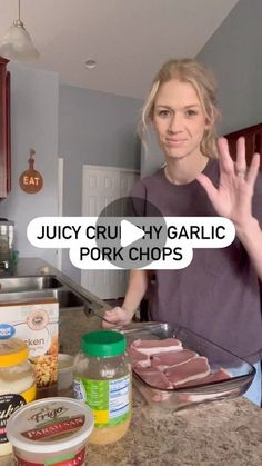 a woman standing in front of a counter with food on it and the words juicy cru - hygarlic pork chops above her