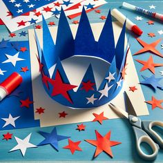 red, white and blue paper stars are cut out to make a patriotic crown for the fourth of july