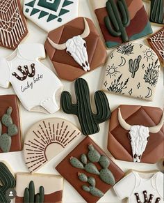 decorated cookies are arranged in the shape of desert animals and cactuses, including longhorns