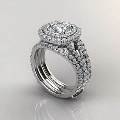 a white gold ring with two rows of diamonds on the band and an oval shaped center stone