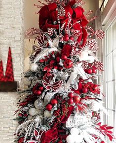 a christmas tree decorated with red and silver ornaments