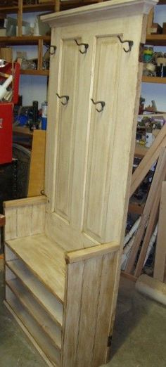 a wooden bench sitting inside of a garage