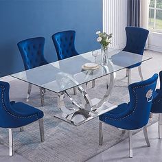 a glass dining table with blue chairs around it