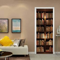 a living room filled with furniture and bookshelves next to a doorway that leads into a library