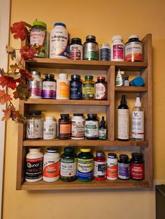 a wooden shelf filled with lots of different types of medicine