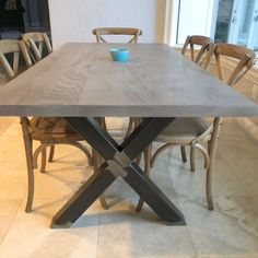 a wooden table with chairs around it