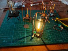 a table topped with lots of different types of lights on top of a green cutting board