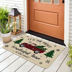 a door mat that says it's the most wonderful time to have christmas trees on it