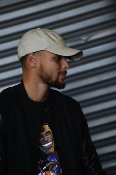 a man wearing a baseball cap and black shirt