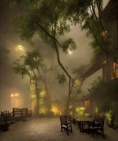 foggy courtyard with benches and tables in the foreground, lit by street lamps