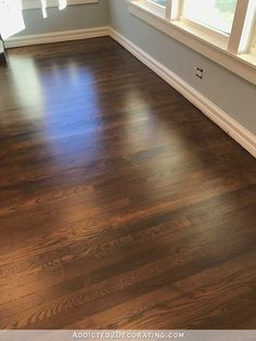 an empty room with hard wood flooring and white trim on the window sill