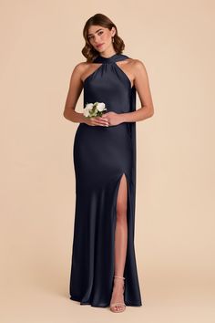 a bridesmaid in a long navy blue dress with a high slit and side slit