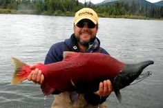 a man holding a large red fish in his hands