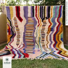 a multicolored blanket sitting in the grass