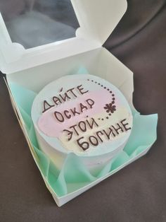 a cake in a box with writing on it