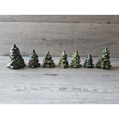 small ceramic christmas trees lined up on a table