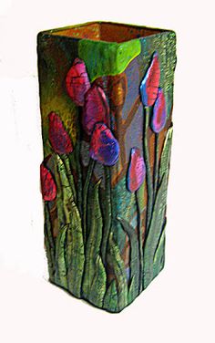 a vase that has flowers painted on it