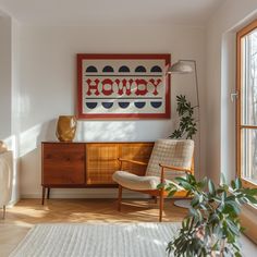 a living room filled with furniture and a painting hanging on the wall over a window