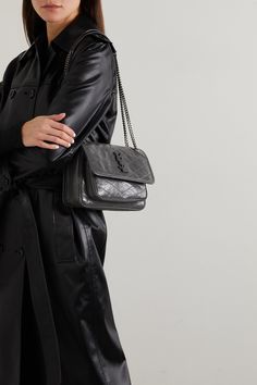 SAINT LAURENT's 'Niki Baby' bag is purposefully crinkled and crackled to look like a vintage find. Made in Italy from glossed-leather, it has a sliding chain strap, so you can alter the drop and is topped with a tonal logo plaque. Despite its mini size, the compartmented interior will easily hold your cell phone, cardholder and compact. Ysl Niki Bag Outfit, Ysl Niki Bag, Chain Bag Outfit, Ysl Bag Outfit, Mini Bag Outfit, Shoulder Bag Outfit, Purse Outfit, Luxury Purses, Mini Quilt