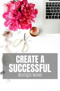 a laptop computer sitting on top of a white desk next to pink flowers and scissors