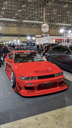 several cars are on display at an auto show