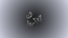 three butterflies flying in the air on a gray and black background with blurry edges