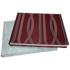 two red and blue notebooks sitting on top of each other